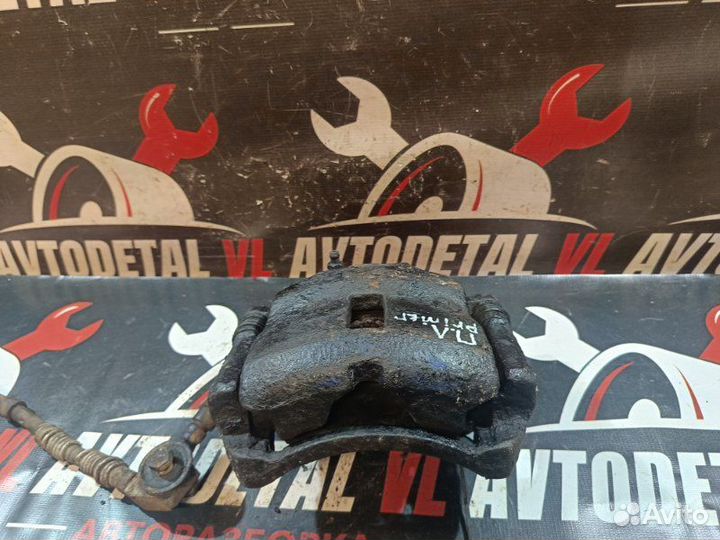 Суппорт тормозной передний левый Nissan Primera