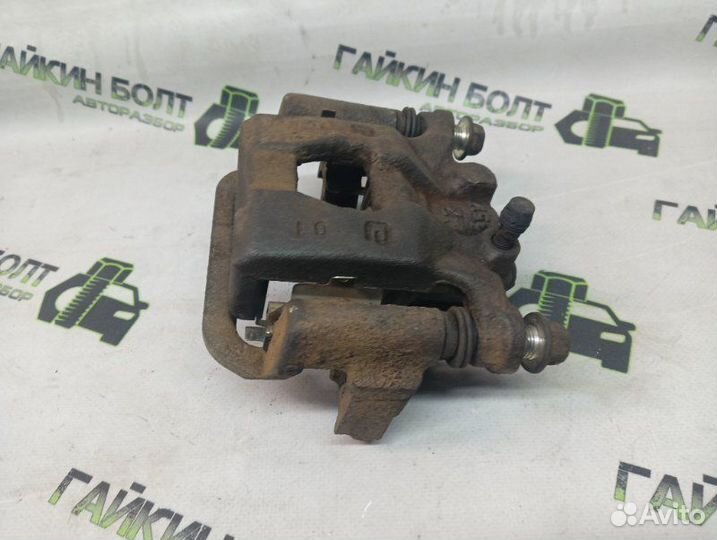 Суппорт тормозной задний левый Nissan Qashqai J10