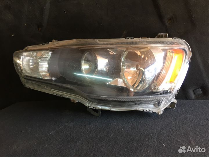 Фара левая Mitsubishi Lancer