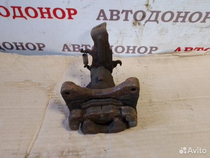 Суппорт тормозной задний левый Nissan Almera Tino