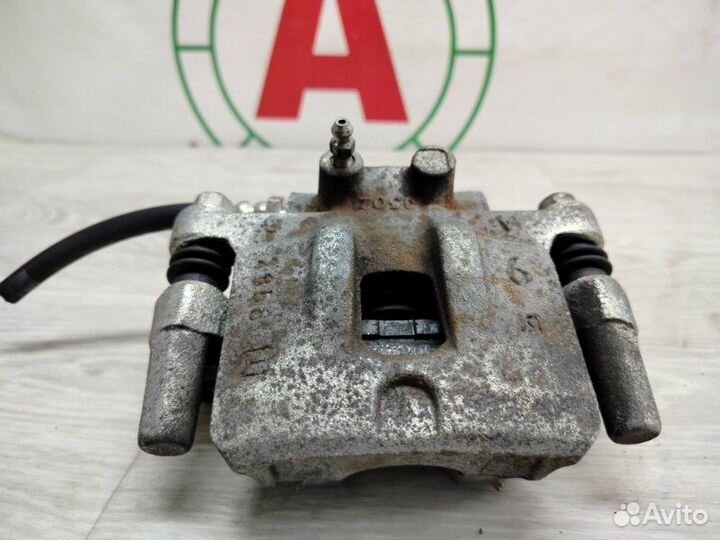 Суппорт тормозной задний левый Mitsubishi Lancer