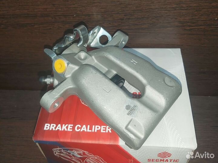 Суппорт тормозной задний левый Opel Astra h Zafira