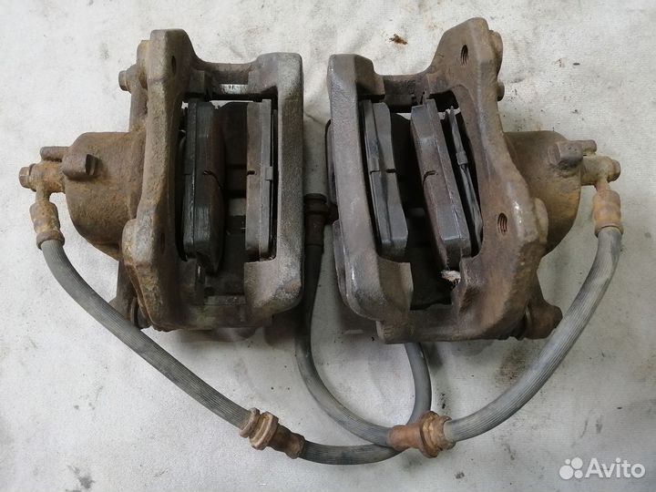 Суппорт тормозной передний для Nissan Primera P11E