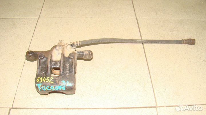 Суппорт задний левый Hyundai Tucson 1 (JM)