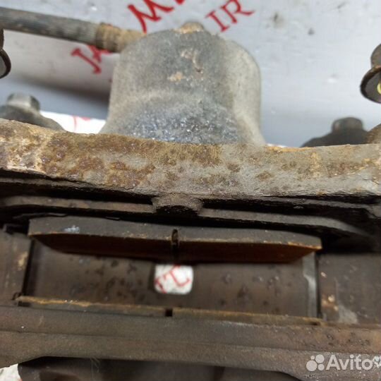 Суппорт тормозной передний левый Nissan Teana J32