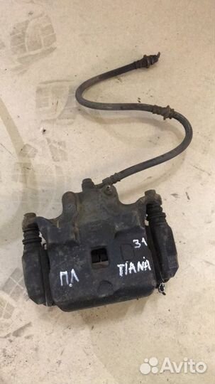 Суппорт тормозной передний левый Ниссан Тиана 31