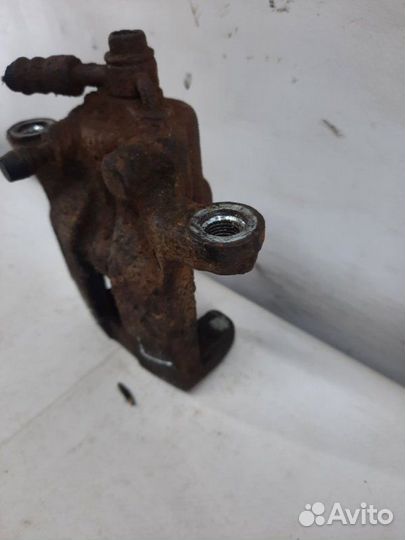 Суппорт тормозной задний левый Nissan X-Trail