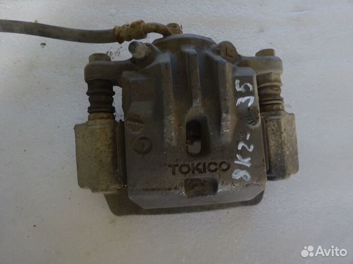 Суппорт тормозной задний левый Subaru Outback B14