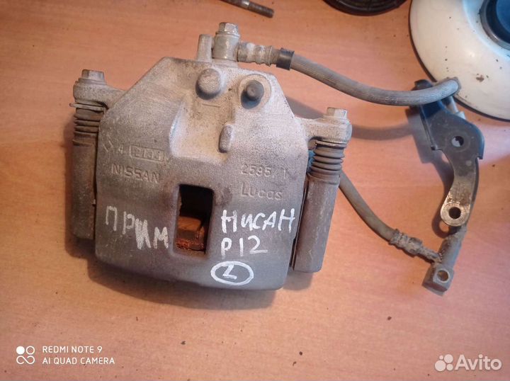 Суппорт тормозной передний левый Nissan PrimeraP12