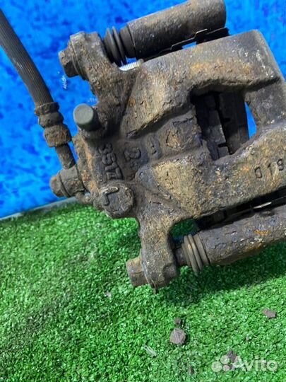 Суппорт тормозной задний левый Nissan Qashqai J10