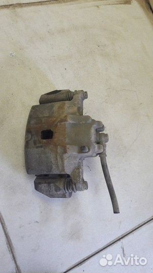 Суппорт тормозной передний левый Mitsubishi Lancer