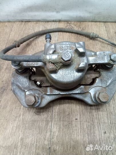 Суппорт тормозной передний левый Mitsubishi Lancer