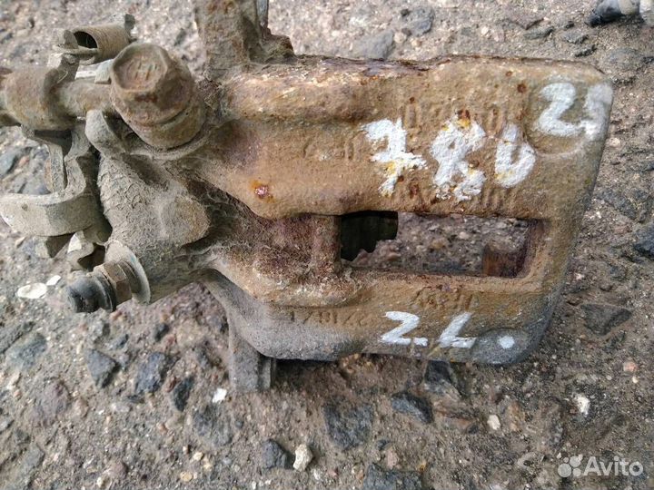 Суппорт тормозной задний левый Nissan Almera N16