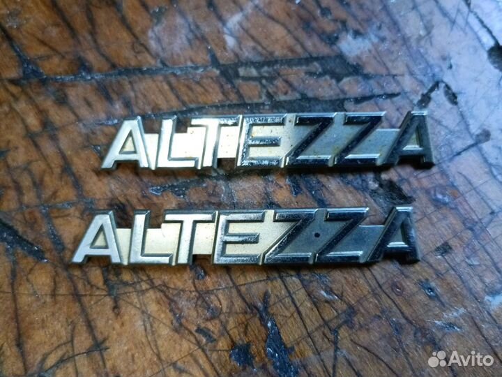 Altezza Эмблема