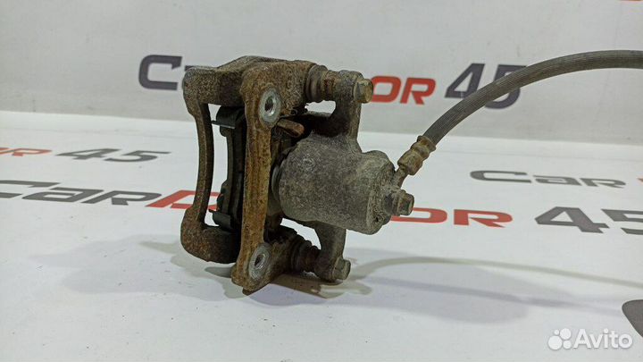 Суппорт задний левый б/у для Kia Sportage (582102Y