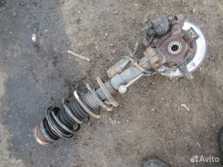 Стойка амортизатора передняя левая Mazda 121 3