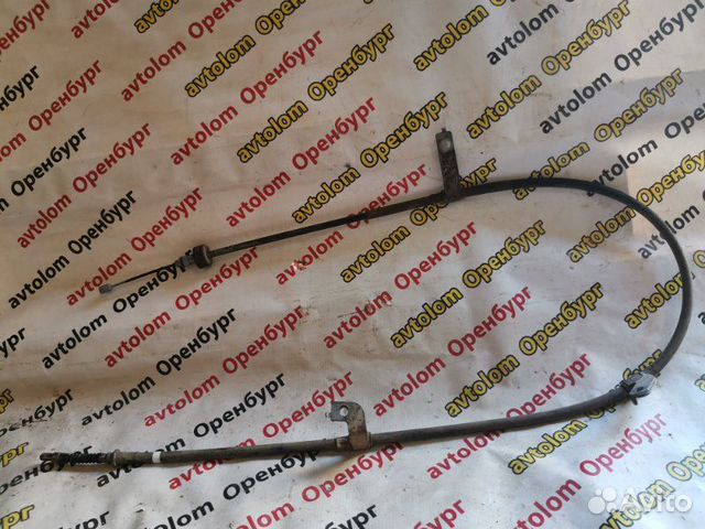 Трос ручного тормоза левый Kia Rio 3