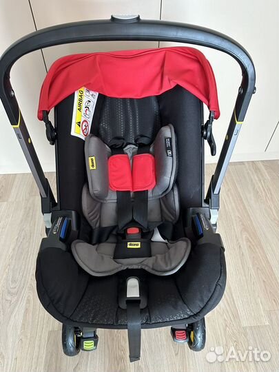 Автолюлька на колесах doona с базой