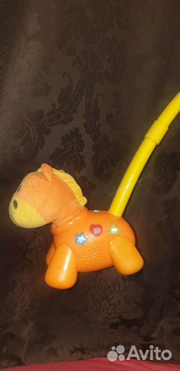 Лошадка каталка музыкальная