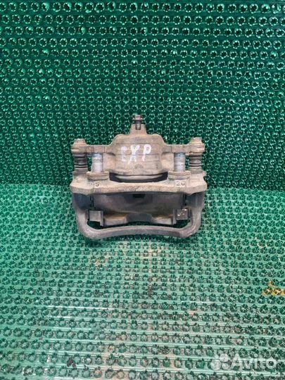 Суппорт тормозной передний левый Nissan Expert