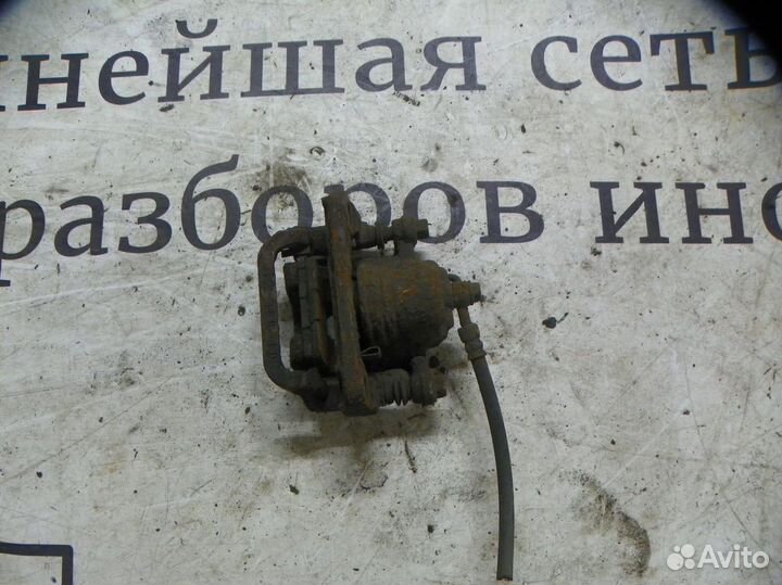 Суппорт тормозной задний левый Nissan Qashqai