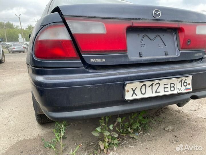 Бампер задний Mazda Familia седан 1997