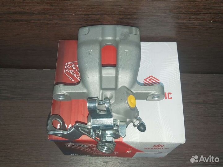 Суппорт тормозной задний левый Opel Astra h Zafira