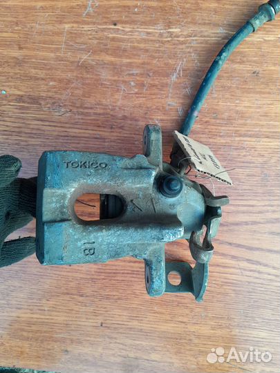 Суппорт задний левый Toyota Corolla 150