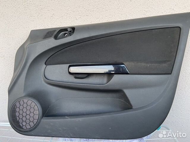 Обшивка двери Opel Corsa