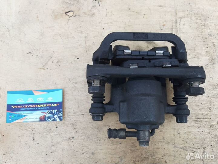 Суппорт тормозной задний левый Nissan Qashqai J10