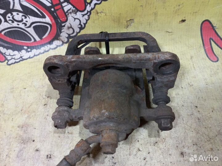 Суппорт тормозной задний левый Nissan Teana J31