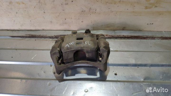 Суппорт тормозной передний левый Mazda Demio DE5FS