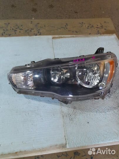 Фара левая Mitsubishi Lancer 10 1.8