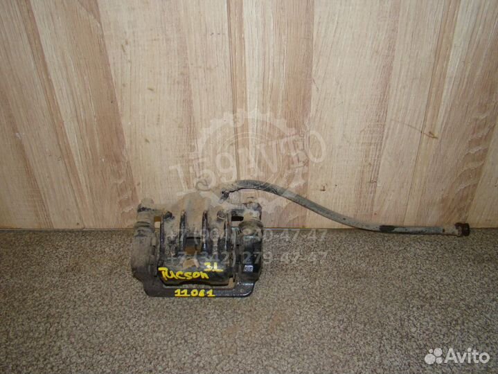 Суппорт задний левый Hyundai Tucson 1 (JM)